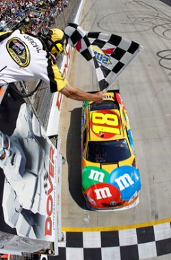 Kyle Busch crosses the finish line to get his second win of the weekend at Dover International Speedway and second NASCAR Sprint Cup Series win of the season. Credit: Todd Warshaw/Getty Images